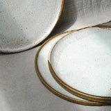 Close-up of ceramic plates with a textured surface on a neutral background