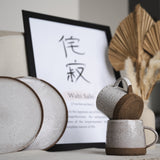 White mugs and white flatplates with wabi sabi frame