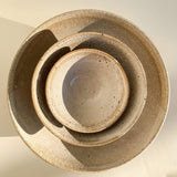Stacked handmade speckled creamy white bowls by Sticky Earth Ceramics SG