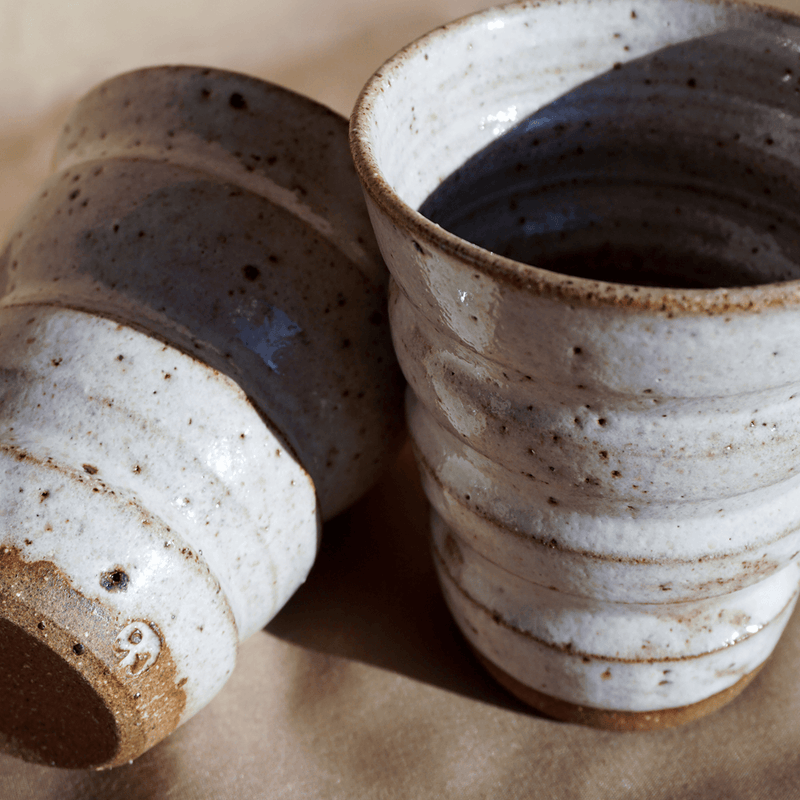 A pair of handmade stoneware ceramic coffee cups