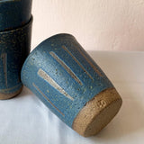 Blue handmade stoneware ceramic cup with prehistoric lines around by Sticky Earth Ceramics SG