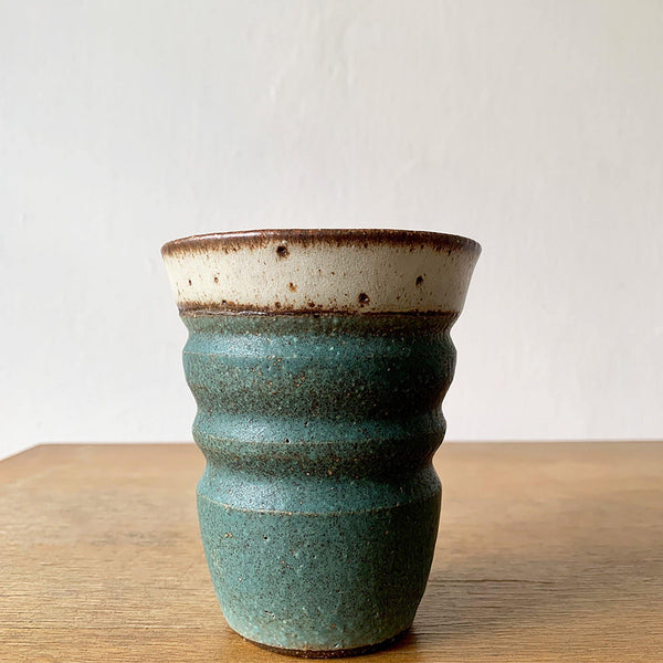 A handmade matte green cup with wide horizontal grooves by Sticky Earth Ceramics SG