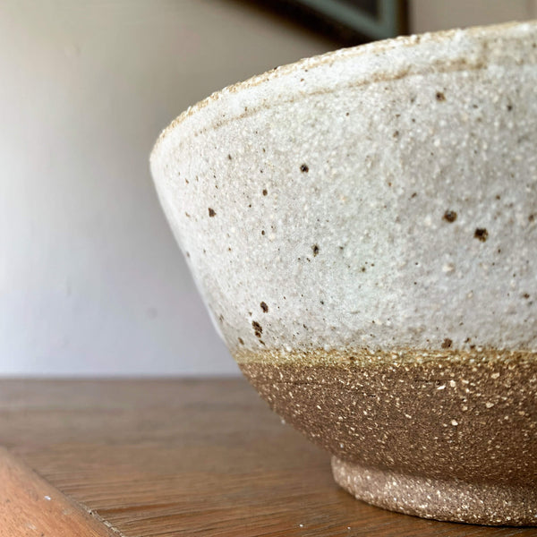 Close up image of Sticky Earth Ceramics SG speckled white bowl's rough bottom texture