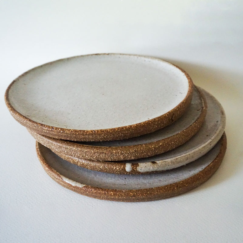 A stack of Speckled White Handmade Ceramic Flat Plate by Sticky Earth Ceramics Singapore 