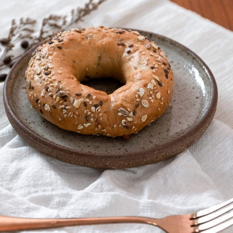 Grained Bagel on a Speckled White Handmade Ceramic Flat Plate by Sticky Earth Ceramics Singapore 